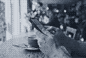 Hands holding a smartphone at a cafe table